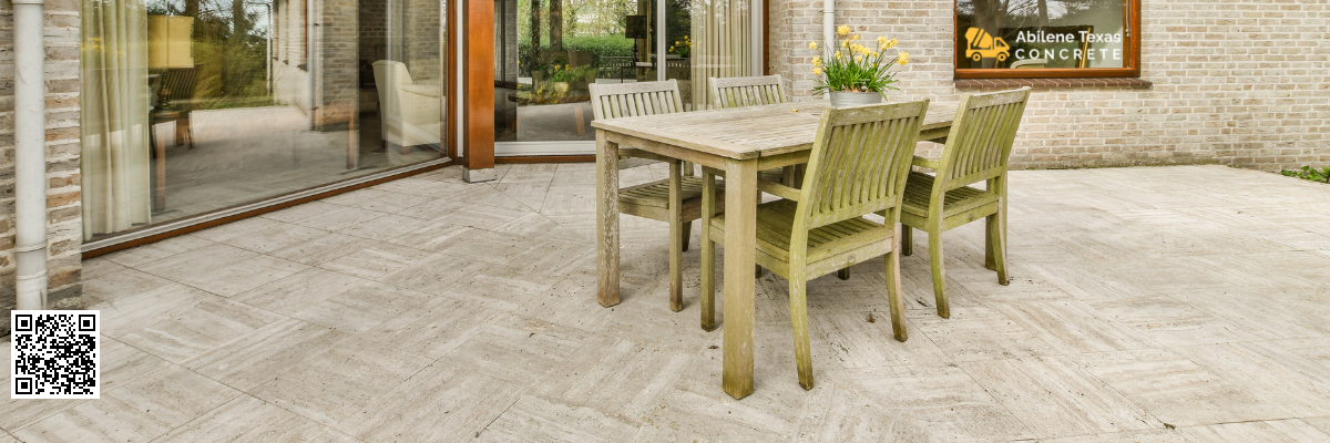 A concrete patio in Abilene, Texas with patio set.