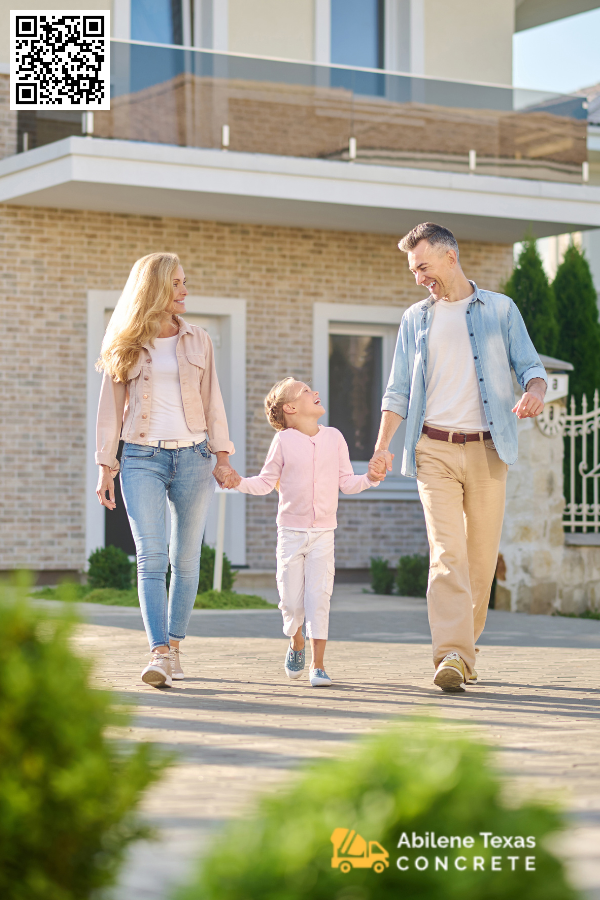 Family in front of home in Abilene with concrete driveway.