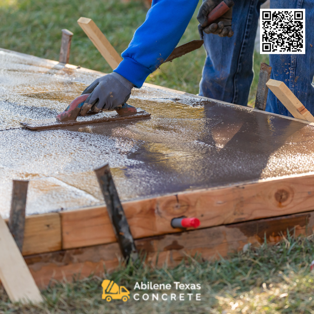 A worker finishing a concrete patio.