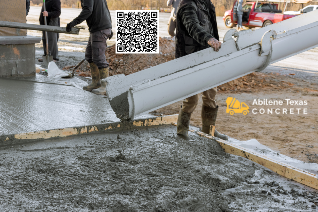 A concrete driveway being poured by contractors.